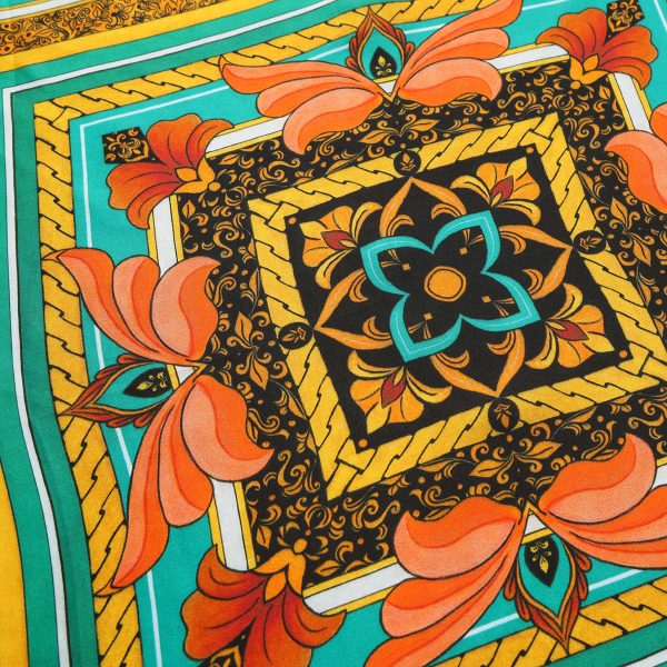 Detalle del medallón central del Pañuelo Seda Olaya con flor turquesa y naranja sobre fondo negro